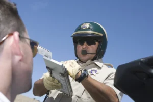 A pilot wearing a helmet and checking an instrument